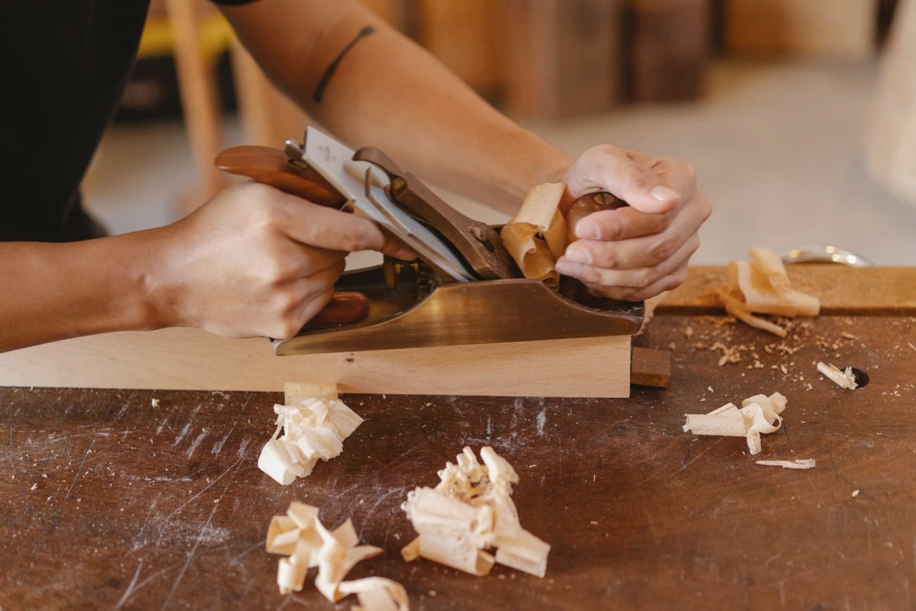 Woodworker shaping a joint by hand